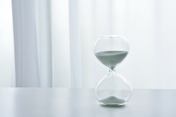 Hourglass on a white desk