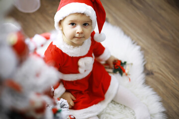 Merry and bright christmas. Lovely baby enjoy christmas. Childhood memories. Santa girl little child celebrate christmas at home. Family holiday.