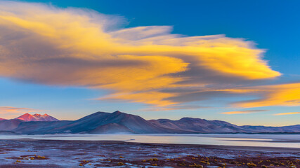 Sunset over volcanoes on the Altiplano of the Andes in the North of Chile