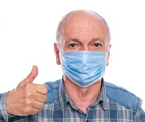 . Senior man in protective mask  posing in studio over white background