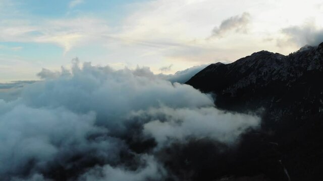 Aerial drone image of the clouds and Mount Baldo during sunset.