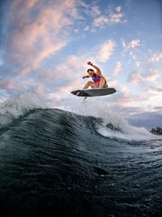 Foto op Plexiglas energetic man engaged in extreme water sports on the surf style wakeboard. © fesenko