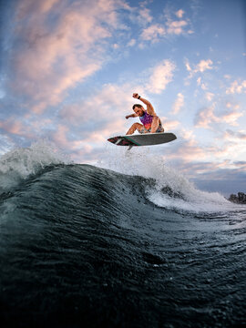 Energetic Man Engaged In Extreme Water Sports On The Surf Style Wakeboard.