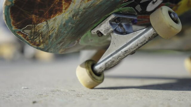 Close up slowmotion shot of a skateboard on the side wheels cinematic 4K