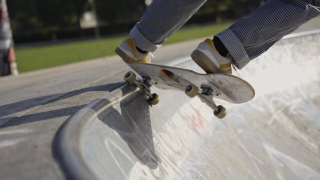 Cinematic slow motion shot of someone doing tricks and grinds in a mini ramp skatepark 4K 