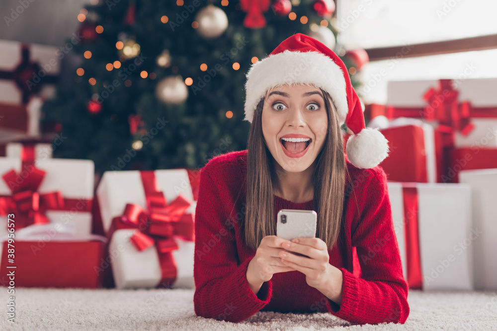 Poster Close-up portrait of her she nice attractive lovely pretty cheerful cheery glad ecstatic brown-haired girl lying on carpet floor using device having fun wear festal hat in light house interior indoor