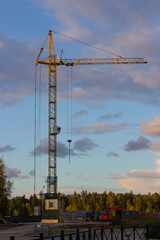 Construction site with crane, dusk evening dramatic sky