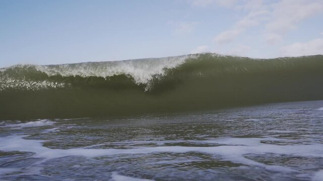 Big powerful wave with a barrel breaking in front of the camera in slow motion 4K