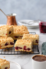 A stack of baked square pieces of cherry pie on a white background.