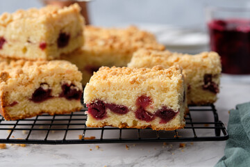 A stack of baked square pieces of cherry pie on a white background.