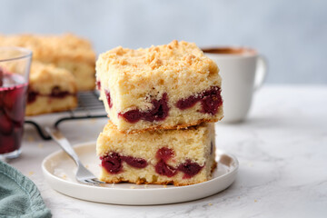 A stack of baked square pieces of cherry pie on a white background.