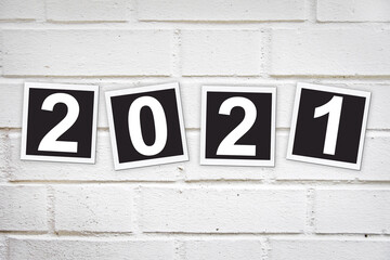 2021 in instant photo frames on a brick wall, new year greeting card