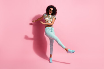 Full length body size photo of funny happy black skinned girl dancing on floor kicking isolated on...