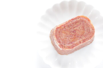 Canned corned beef on white dish with copy space