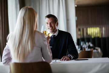 Handsome businessman drinking wine. Businessman enjoying in the restaurant