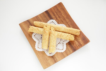 Chinese food, asian confectionery egg roll cookie on wooden plate