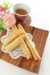 Chinese food, asian confectionery egg roll cookie on wooden plate