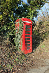 Red old British disused telephone box