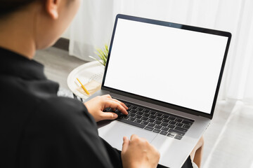 Hand using laptop with blank copy space screen for your advertisement. on the table in office.