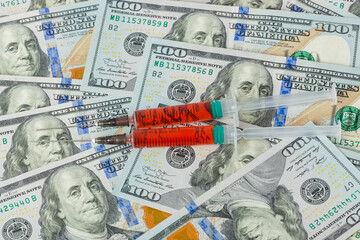 Fototapeta premium Syringes and money - business medical background