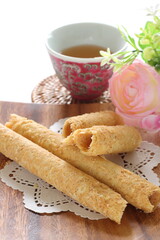 Chinese food, asian confectionery egg roll cookie on wooden plate