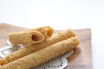 Chinese food, asian confectionery egg roll cookie on wooden plate