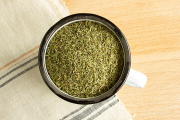 crushed thyme in zinc cup