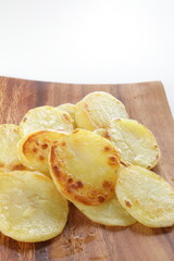 homemade fried potato on wooden plate with copy space