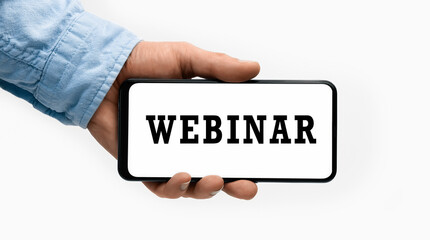 Closeup of a male hand holding Smartphone with word webinar on display