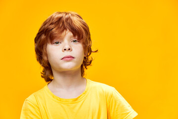 Cute boy red hair cropped view studio yellow t-shirt 