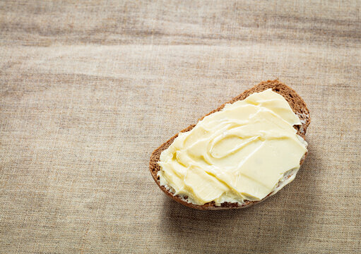 piece of bread with butter isolated white background