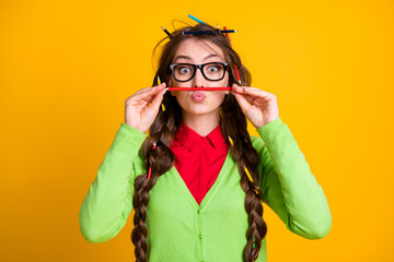 Photo of geek girl messy haircut put pencil nose lips isolated yellow color background