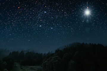 Fototapeta premium The star shines over the manger of christmas of Jesus Christ.