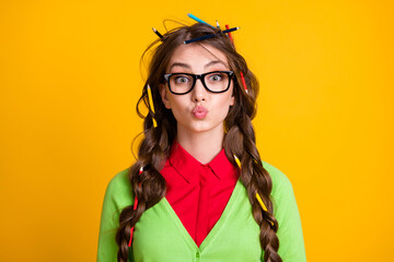 Photo of nerd teen girl with pencil haircut send air kiss isolated over yellow color background