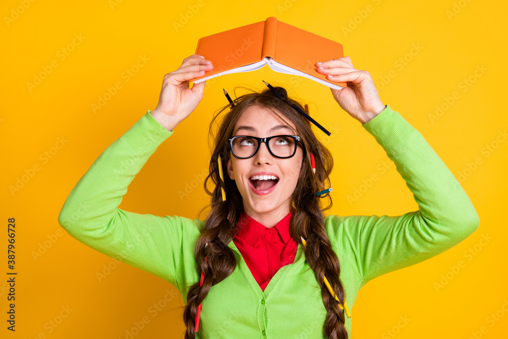 Canvas Prints Close-up portrait of lovely funky clever cheerful teenage girl reading book literacy isolated over bright yellow color background