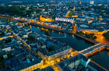 Evening aerial view of Laval with buildings, river Mayenne and old bridge, Mayenne department, north-western France