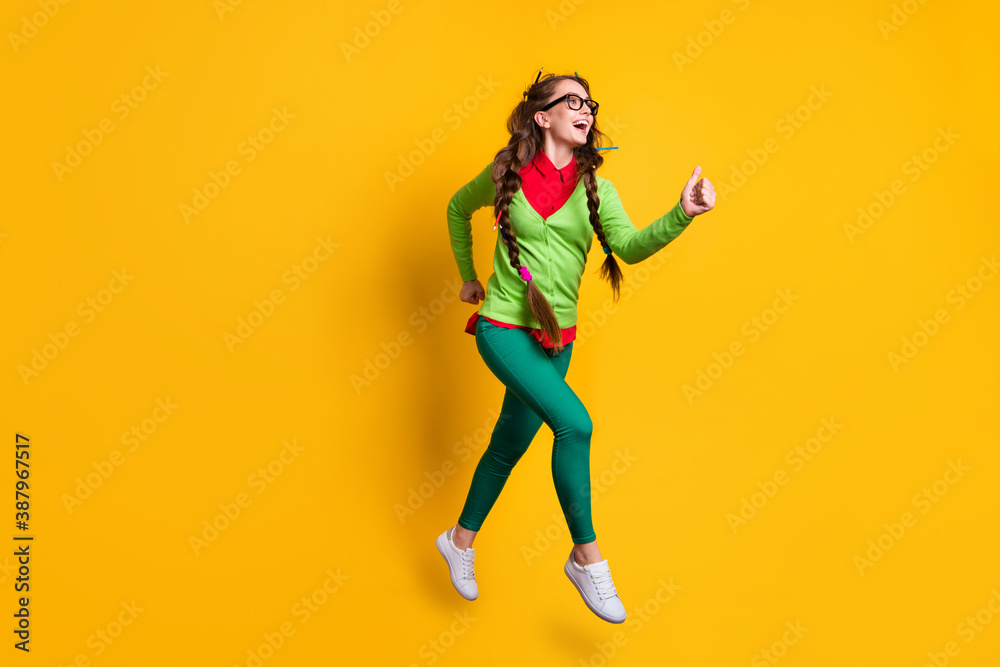 Poster Full length body size view of attractive funky cheerful girl jumping running 1 September isolated bright yellow color background