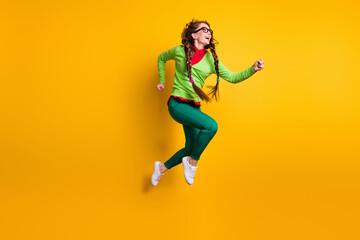 Fototapeta na wymiar Full length body size view of attractive funky cheerful girl jumping running motivation isolated bright yellow color background