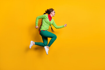 Fototapeta na wymiar Full length body size profile side view of pretty funky energetic cheerful girl jumping running isolated bright yellow color background