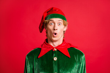 Portrait of astonished elf guy look in camera unbelievable news hear wear green costume hat...