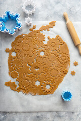 Christmas baking cookies snowflakes shape. Raw dough, cookie cutters, rolling pin. Abstract winter food background.