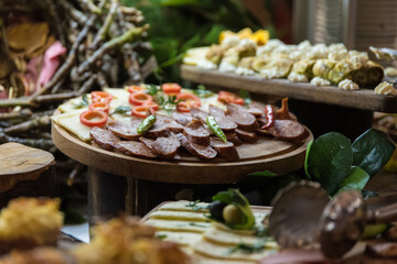 Delicious appertizer catering food in the countryside on wooden table