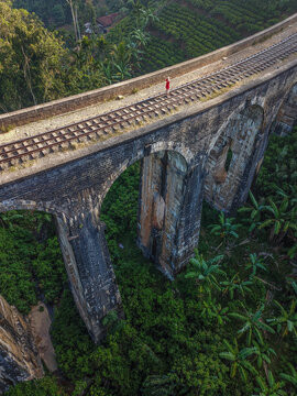 Aerial view of girl standing on the Nine Arch Bridge in Ella, Sri Lanka