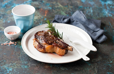 Grilled cowboy or rib eye steak on a plate, selective focus