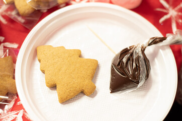 Gingerbread in the shape of Christmas tree is ready to decorate with glaze. Decorating gingerbreads, step 3. Preparing for the Christmas or New Year concept. Xmas at home concept. 