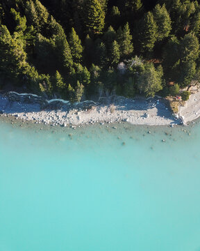 Aerial view of trees and blue water of Lake Pukaki, South Island, New Zealand