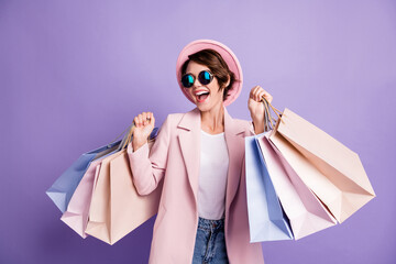 Photo of amazed pretty optimistic brunette young lady do shopping wear glasses pink cap coat...