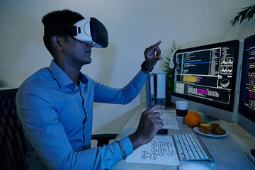 Software developer in VR headset testing new applciation he was working on