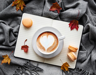 Maple leaves, notebook, coffee cup and scarf.