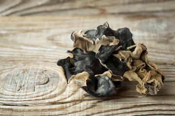 Dry Chinese black muer mushroom on a wooden background